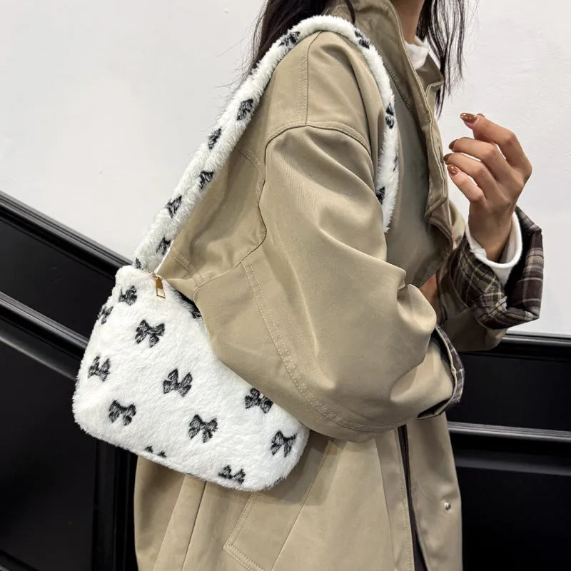 Contrast colour fur and flannel shoulder bag with bow and stitching in pink