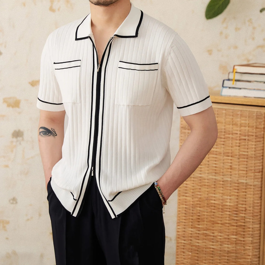 Black slim-fit men's polo shirt with a lapel collar and short sleeves on a hanger.