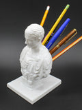 White synthetic resin American creative character pen holder on a desk
