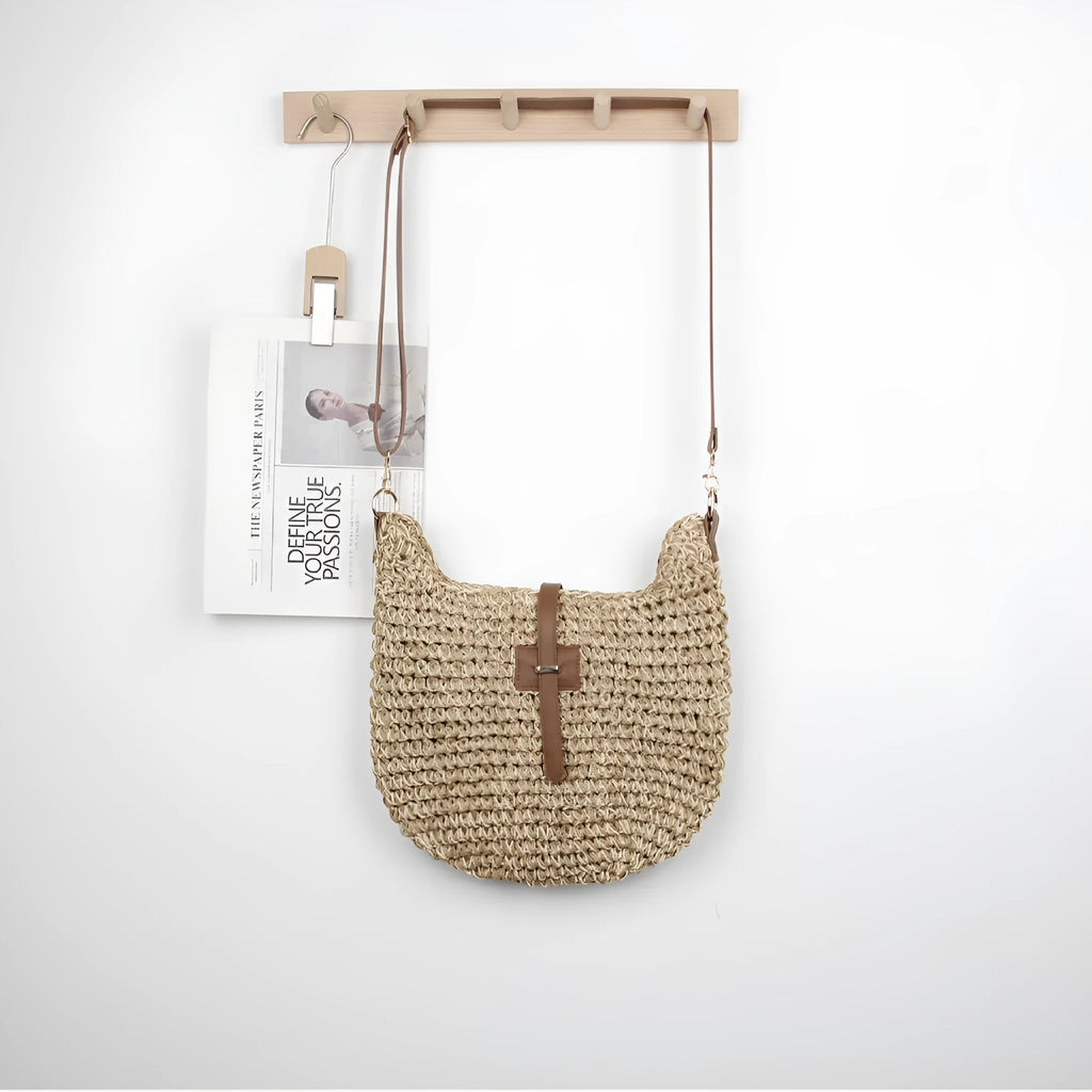 Handmade beige square woven bag with a shoulder strap on a neutral background.
