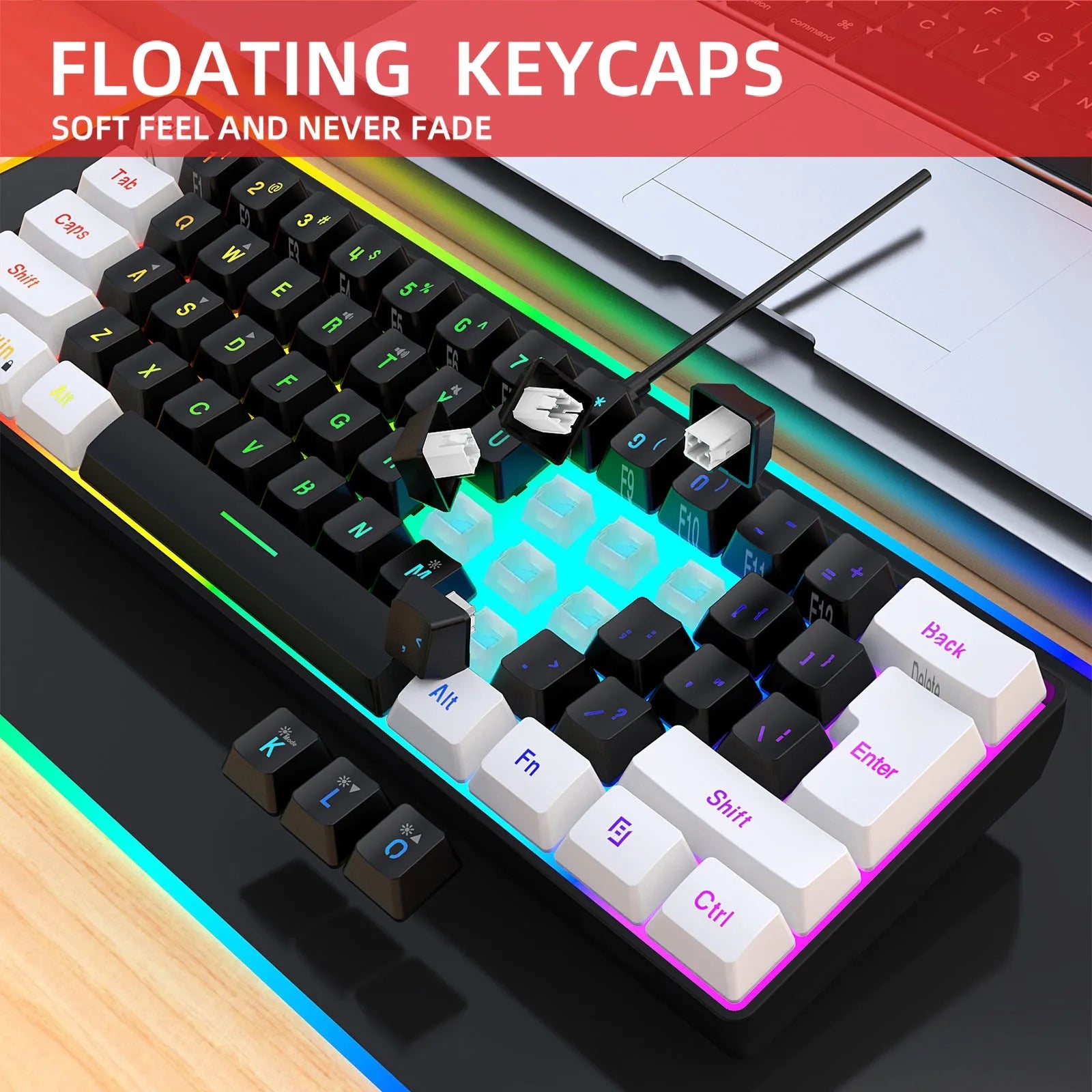 White and black wired 61-key USB membrane keyboard on a desk next to a laptop.