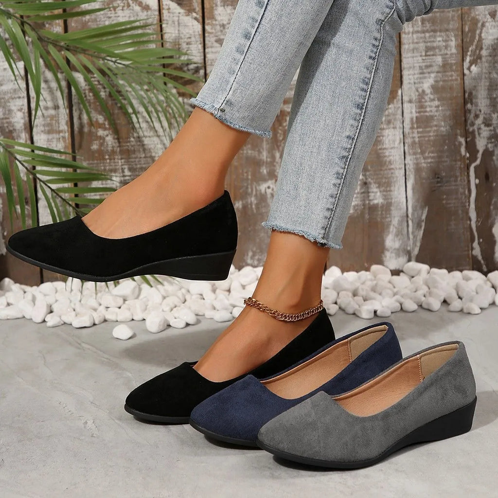 Women's light brown suede wedge pumps with a round toe and shallow mouth design on a rubber sole.