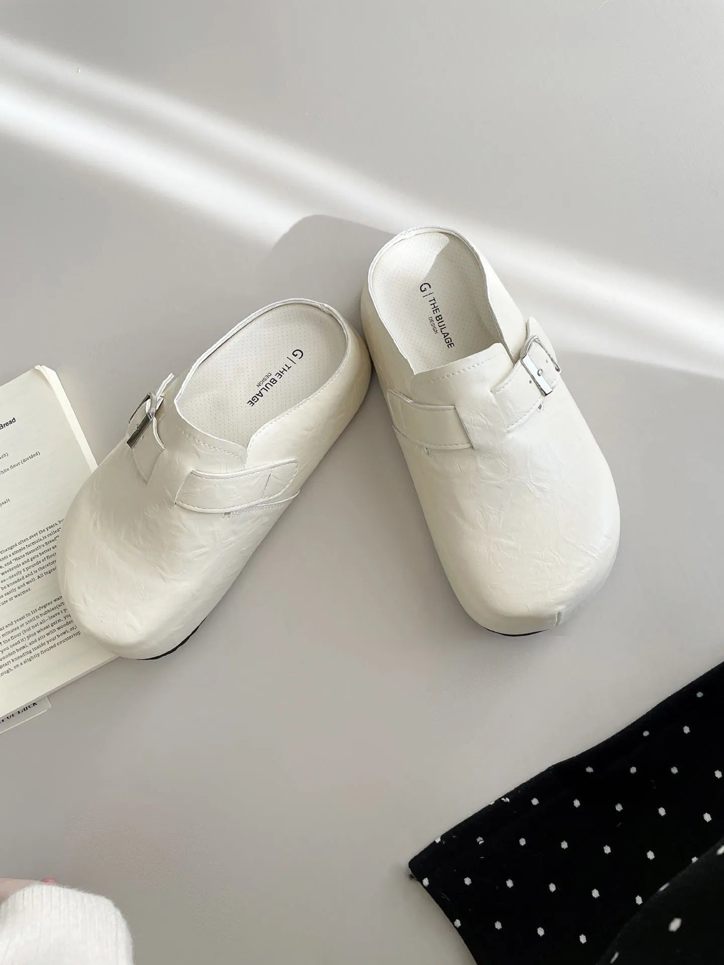Flat buckle casual slippers with round toe and PU upper in beige colour on a clean surface