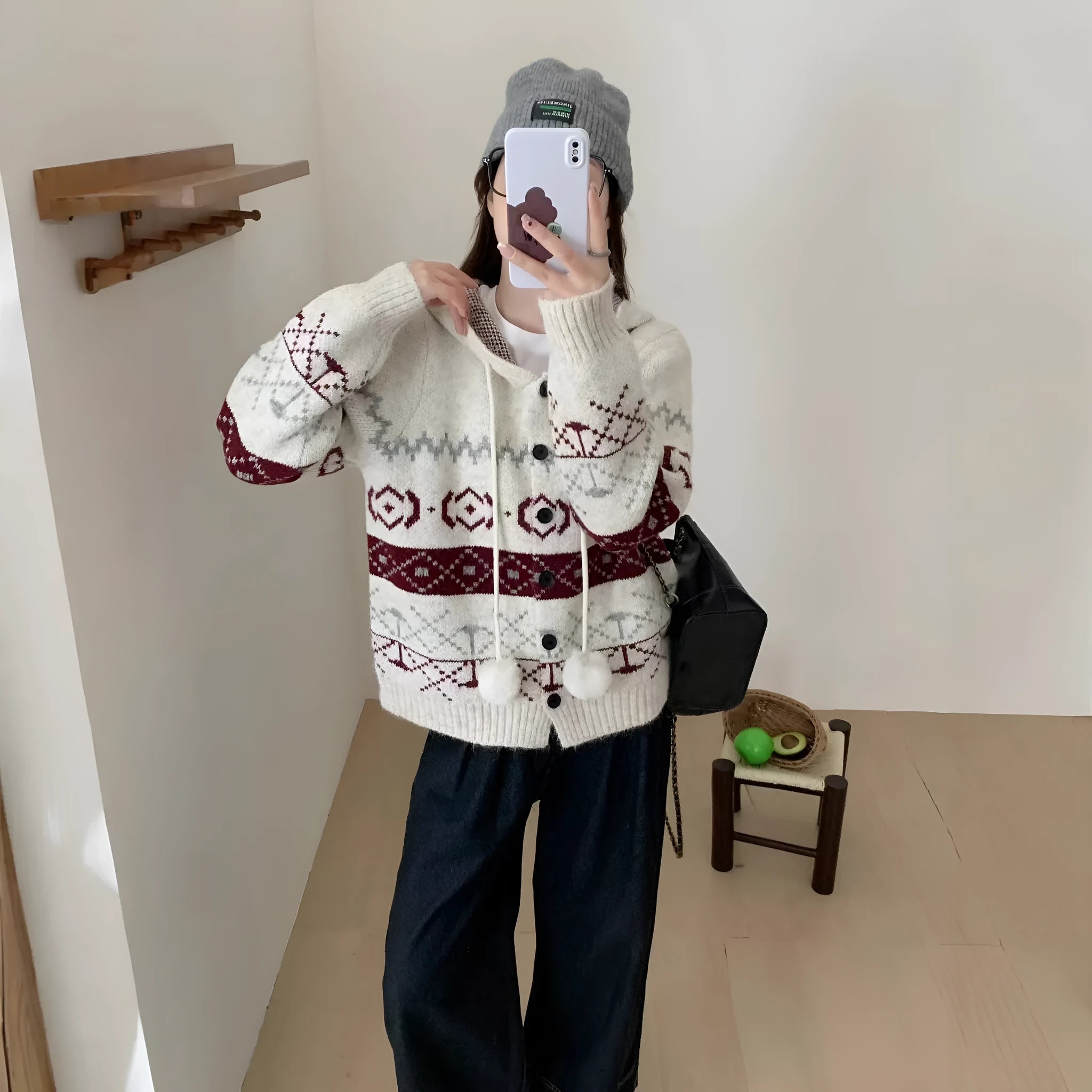 Plus size woman wearing a loose milky white geometric brocade sweater coat with long sleeves.