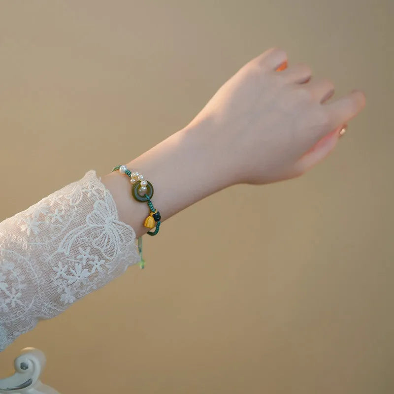Hand-woven DIY watch band with flexible wire and a round pearl peace buckle closure.
