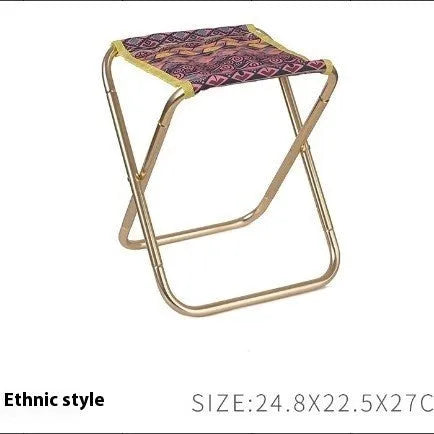 Black ethnic style aluminium alloy folding camping stool shown in use outdoors.