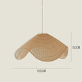 Handmade bamboo and straw rattan chandelier ceiling light with warm LED illumination in a rustic setting.