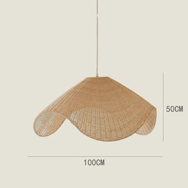 Handmade bamboo and straw rattan chandelier ceiling light with warm LED illumination in a rustic setting.