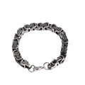 Retro black polished stainless steel geometric chain bracelet on a neutral surface