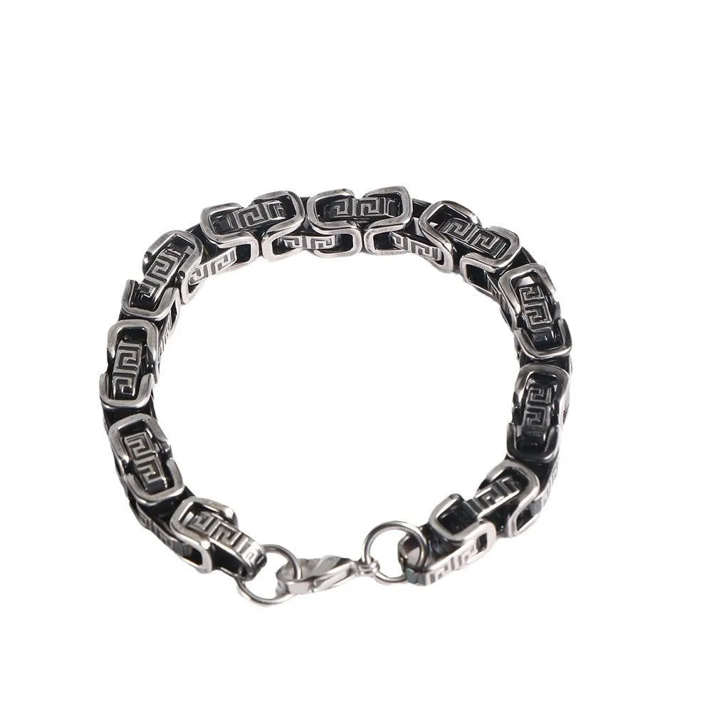 Retro black polished stainless steel geometric chain bracelet on a neutral surface
