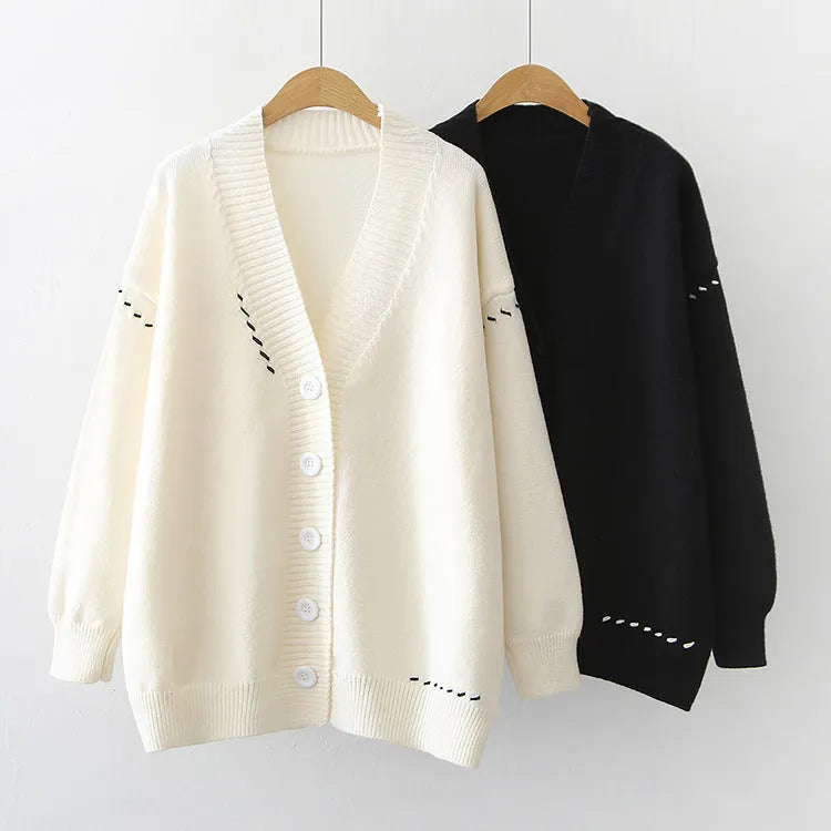 Women's loose-fitting knitted cardigan top coat in black, showing long sleeves and solid colour design.