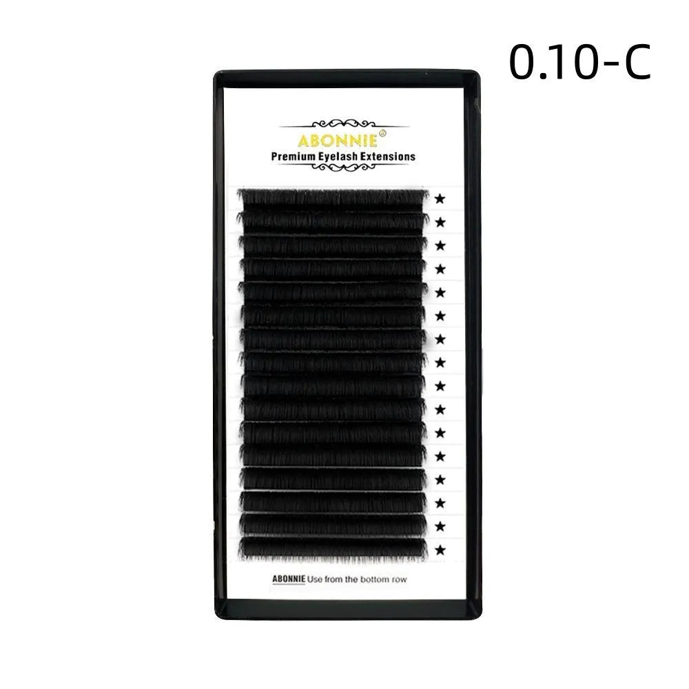 Pair of 16-row dense false eyelashes made from mink hair, showing matte round wool texture on a clear band.