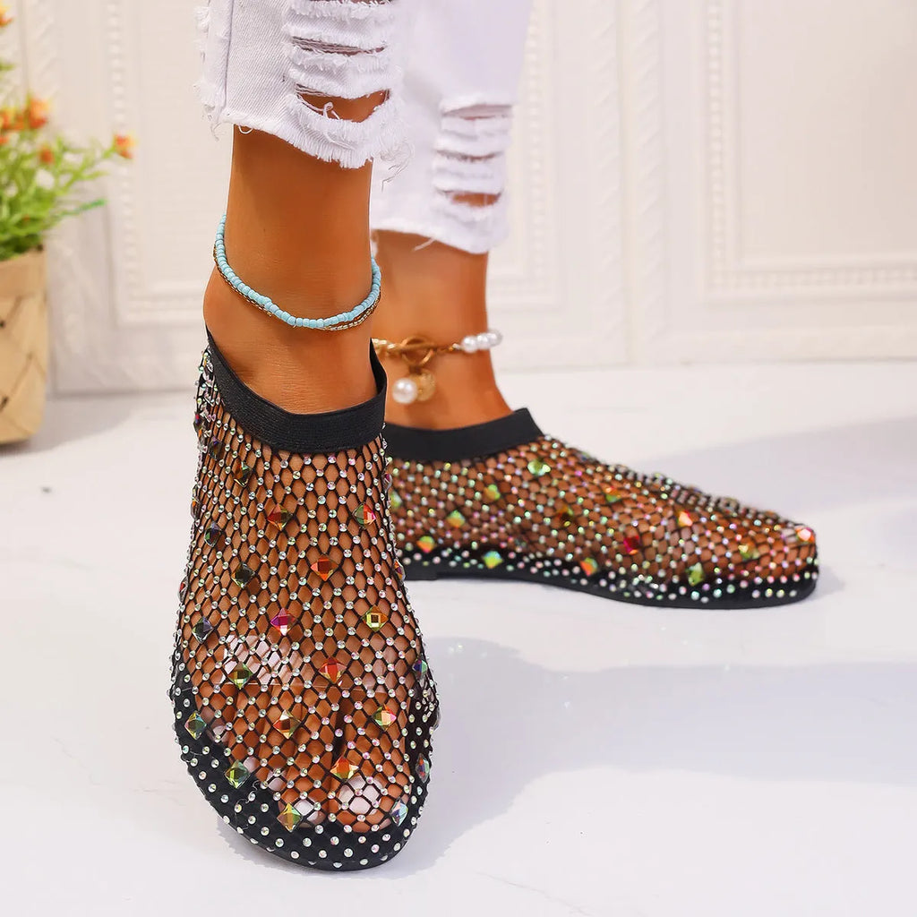 Women's white and colourful mesh flat sandals with rhinestone decoration and a round toe.