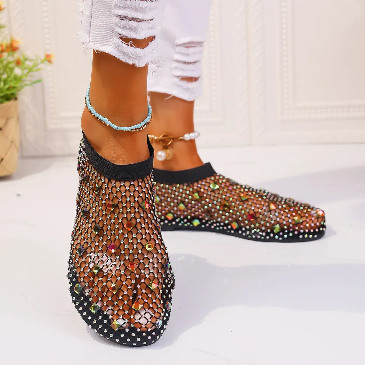 Women's white and colourful mesh flat sandals with rhinestone decoration and a round toe.