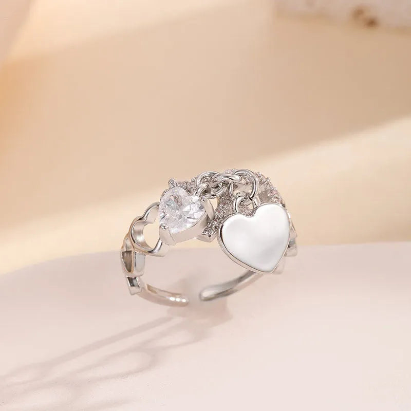 Silver electroplated copper adjustable heart ring for women on white background