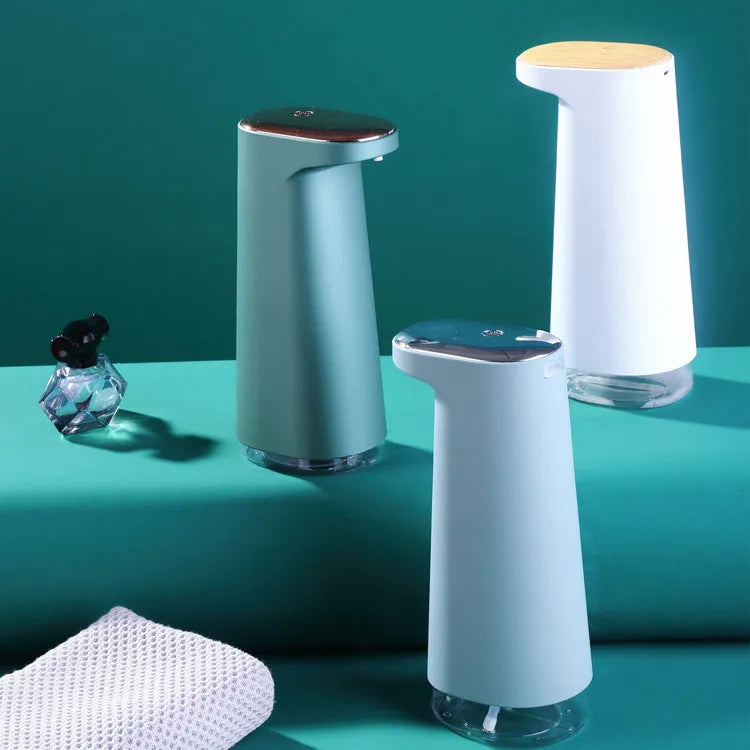 White automatic foam soap dispenser with infrared sensor for touch-free operation on a bathroom counter.