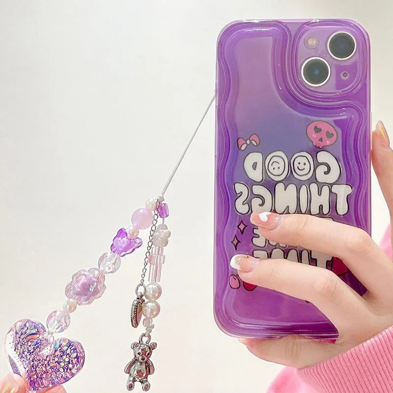 Purple graffiti love design iPhone 14 phone case with an attached silver chain bracelet.