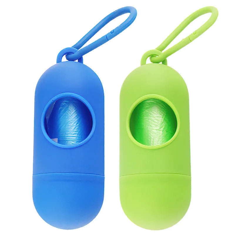 Compact black dog poop bag holder with a metal side hook and a grey Velcro adjustment strap.