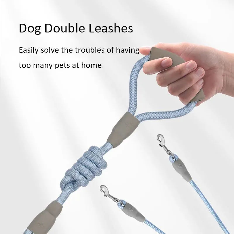 Blue double dog leash for two pets with foam-padded handle and metal clips.