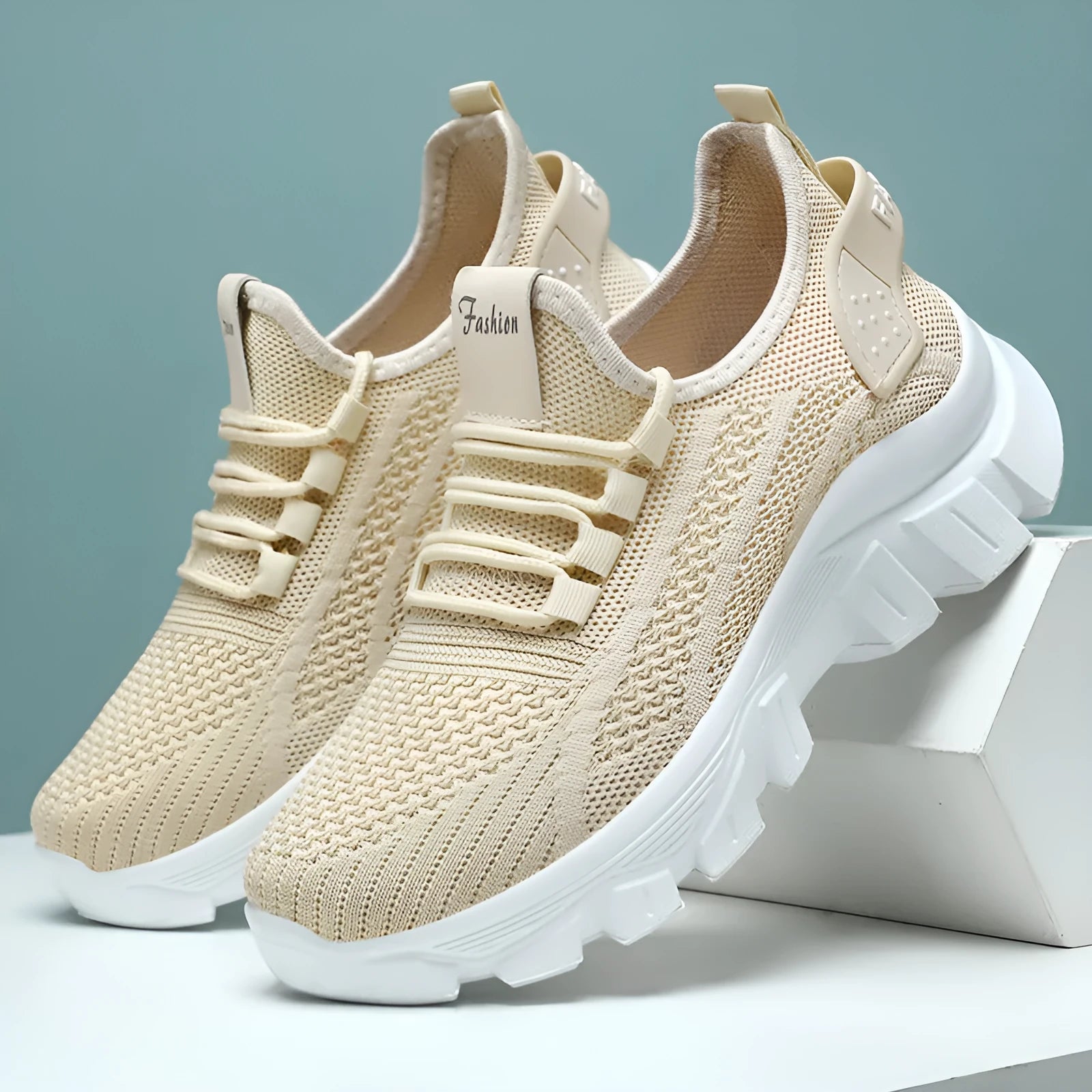 Women's Flyknit sneakers with thick PVC sole in beige colour showing lace-up front and round toe design