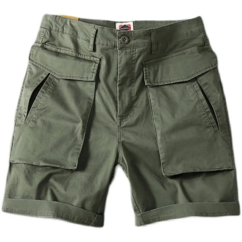 Men's straight-leg cotton cargo shorts in khaki with multiple pockets, shown on a model for summer street style.