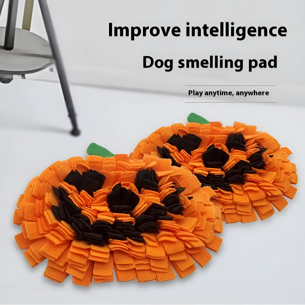 Orange pumpkin-shaped fleece pet slow feeder mat for dogs and cats on a floor.