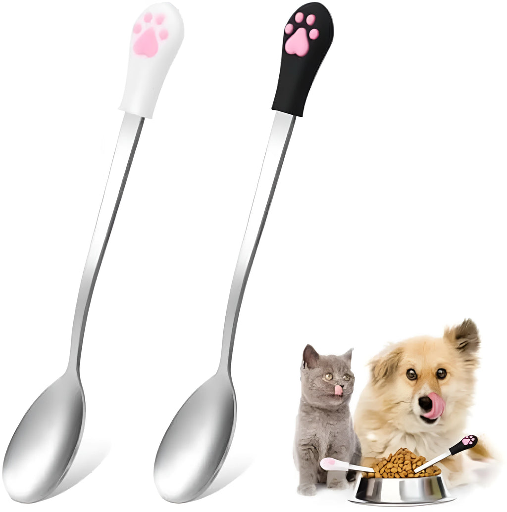 Two stainless steel pet food spoons with silicone grips, one white and one black, featuring a cat paw print.