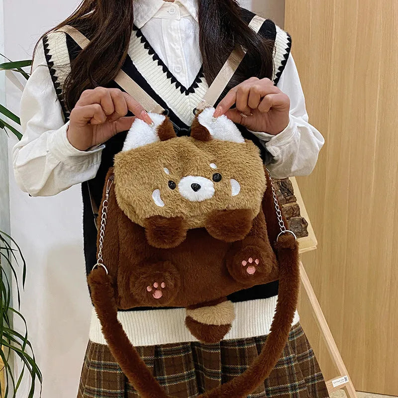 Brown coati plush bag doll cartoon backpack on display showing soft fabric and animal face design