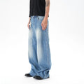 Cut washed vintage washed wide leg machete jeans in light blue denim fabric with zip fly