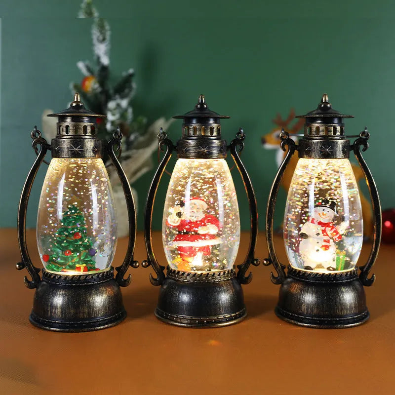 Plastic crystal ball LED oil lamp Christmas decoration showing internal snowman scene on a desktop.
