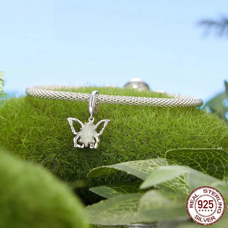 925 sterling silver butterfly pendant with green natural jade inlay on a white background