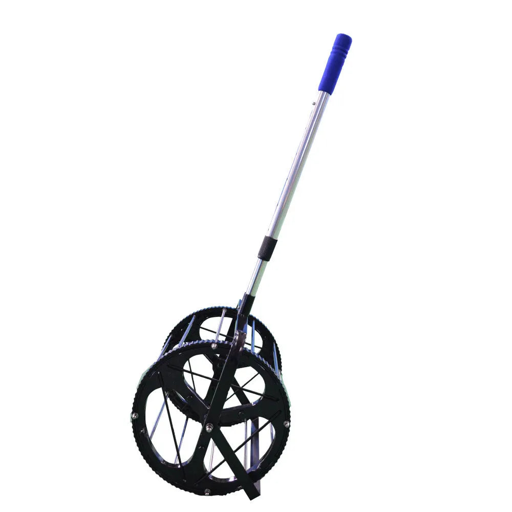 Black tennis ball picker basket made from nylon and metal, holding multiple tennis balls on a court