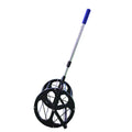 Black tennis ball picker basket made from nylon and metal, holding multiple tennis balls on a court