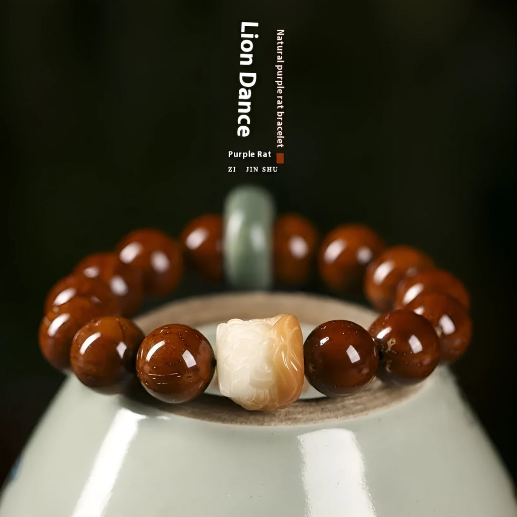 Hand-woven bracelet with 13mm round beads and a carved lion bead centrepiece in ivory nut style.