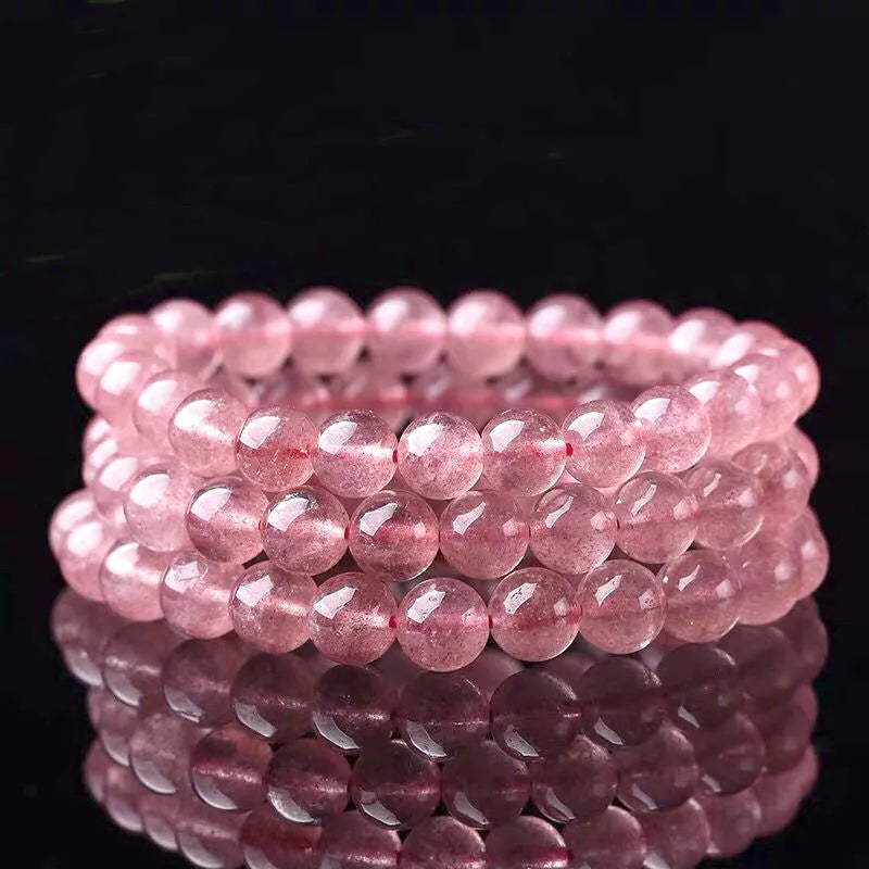 Women's strawberry quartz crystal bracelet with polished beads in 6mm, 8mm, or 10mm diameter options