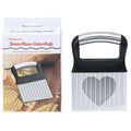 Stainless steel potato wave knife for making crinkle-cut chips on a wooden kitchen surface.
