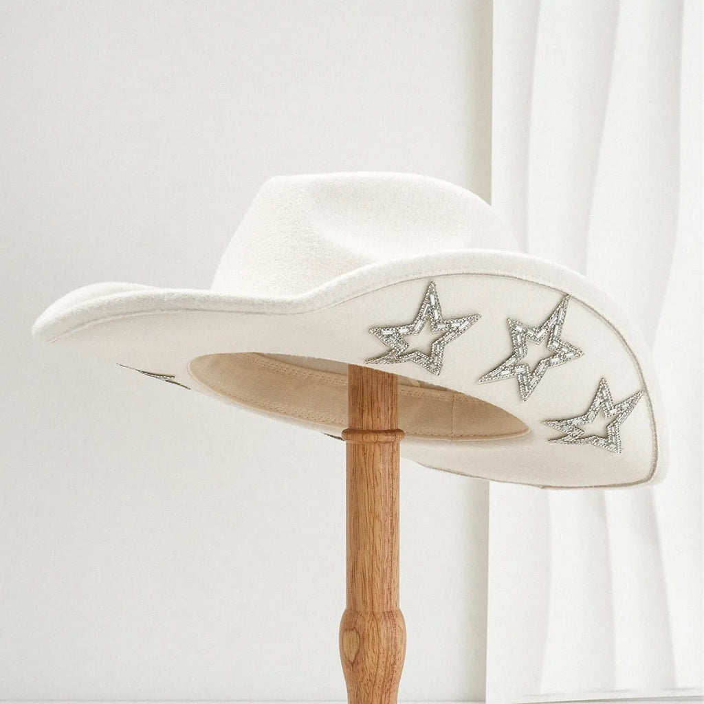 Beige woolen felt Western top hat with a conical crown and a decorative hexagonal star on the front.