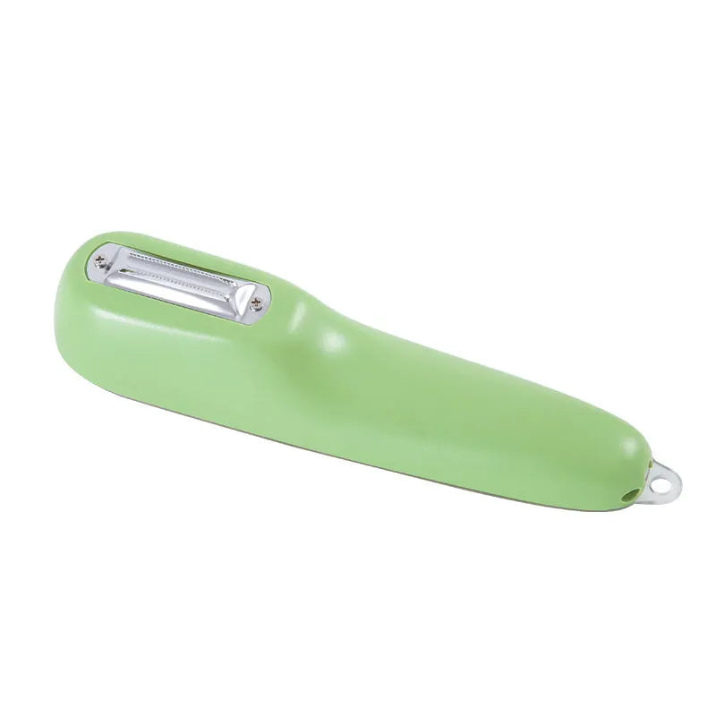 Dark green kitchen peeler with storage tube and stainless steel blade on a worktop.
