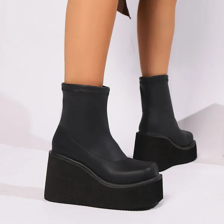 Plus size black wedge heel boots with a waterproof platform and high cylinder design.