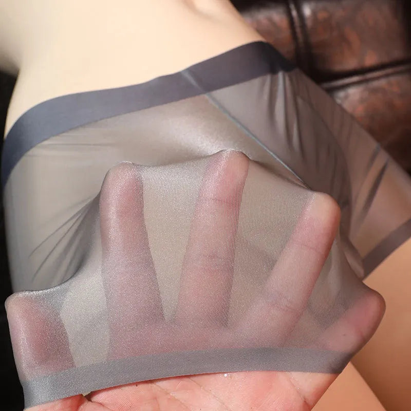 Men's light grey ice silk boxer underwear laid flat, showing ultra-thin nylon fabric.