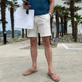 Men's straight-leg casual shorts in solid black, shown laid flat, featuring a non-iron polyester fabric.