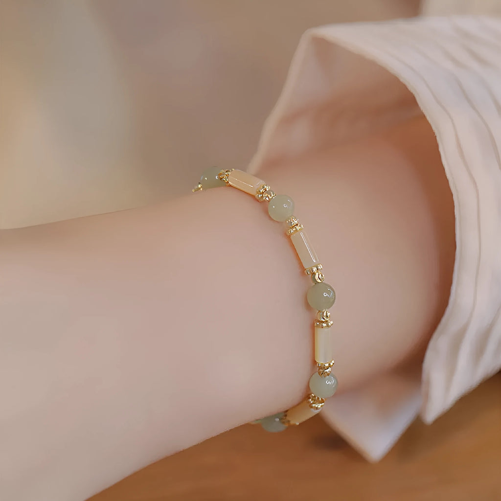 Casual women's bamboo joint bracelet made from 6mm Hetian jade beads in jade or red.
