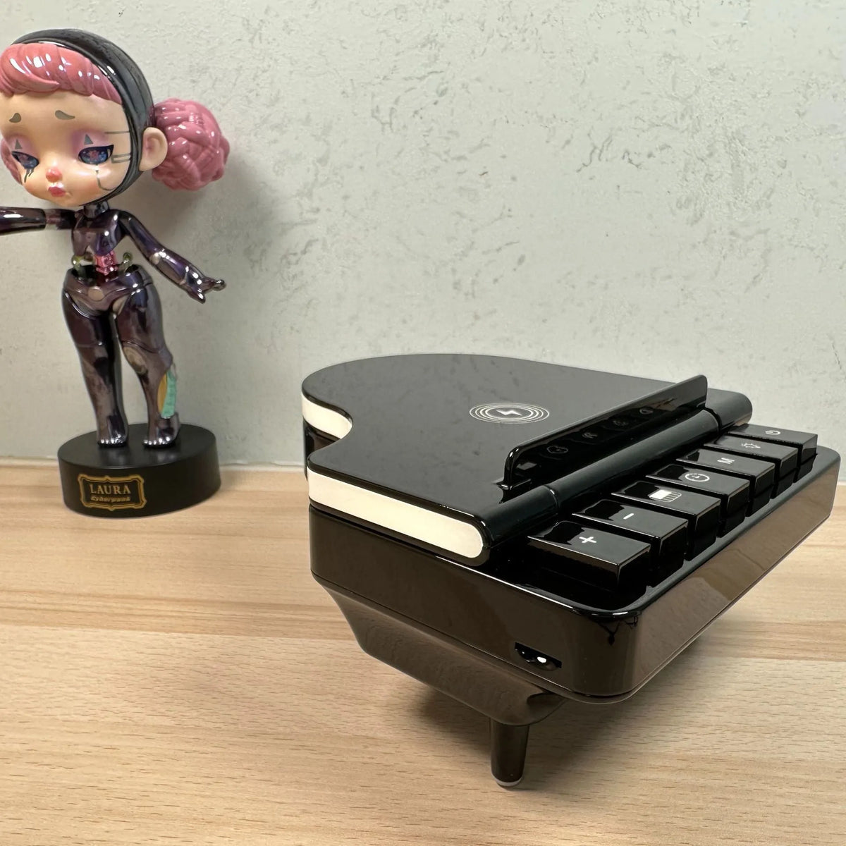 Black multi-function Bluetooth speaker with wireless charger and phone holder showing LED lighting