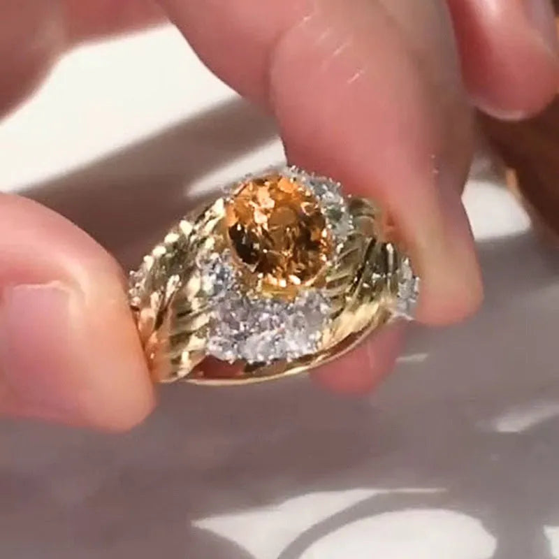 Women's gold embossed feather ring with geometric design and yellow zircon stones