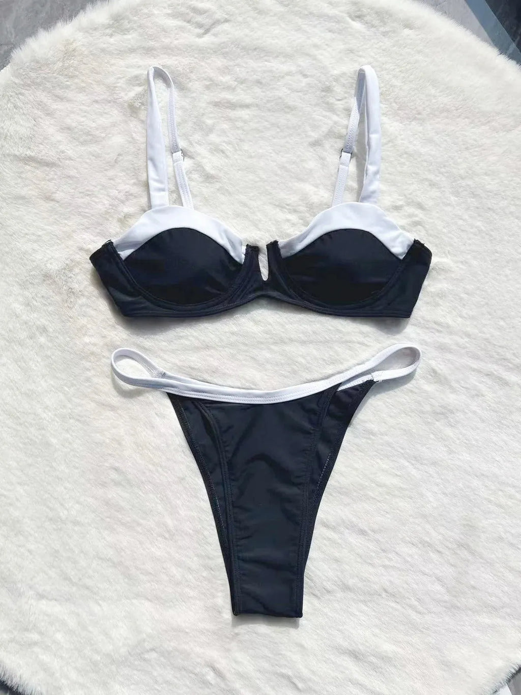 Black low waist women's bikini swimsuit with stitching split detail on the briefs.