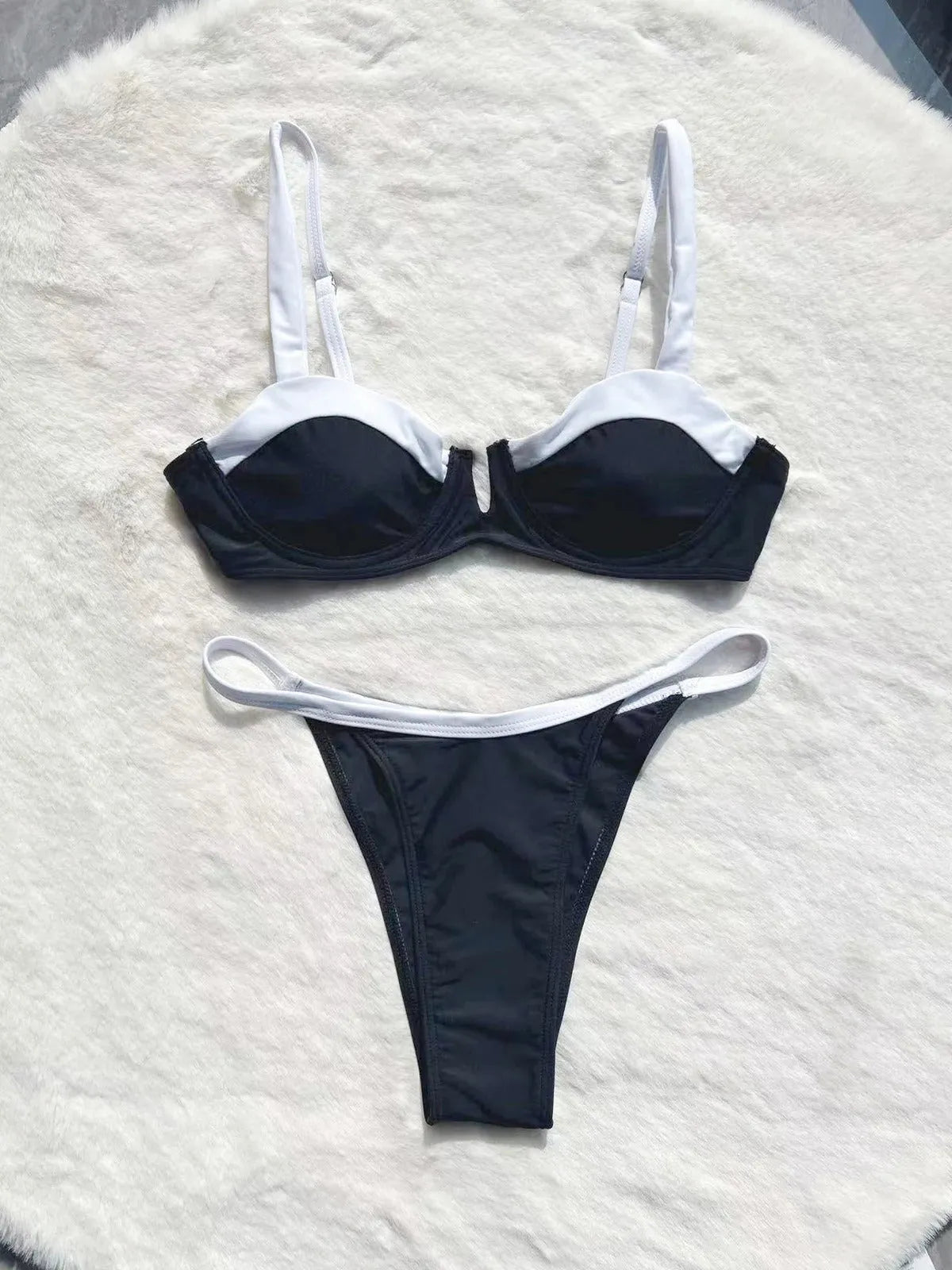 Black low waist women's bikini swimsuit with stitching split detail on the briefs.