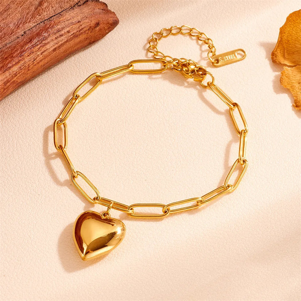 Titanium steel round chain bracelet with heart charm and petal detailing in gold N510