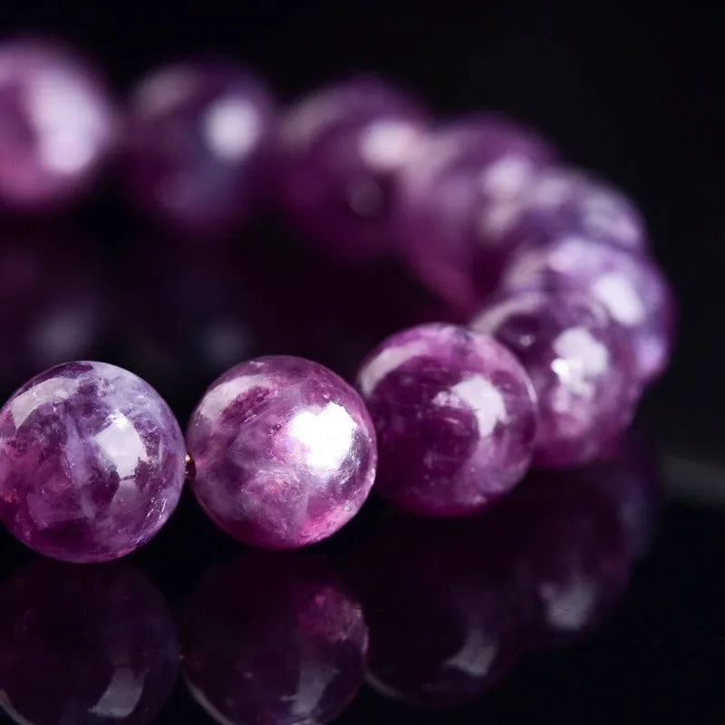 Grandmother Crystal bracelet with polished geometric beads in 5A purple on a white background.