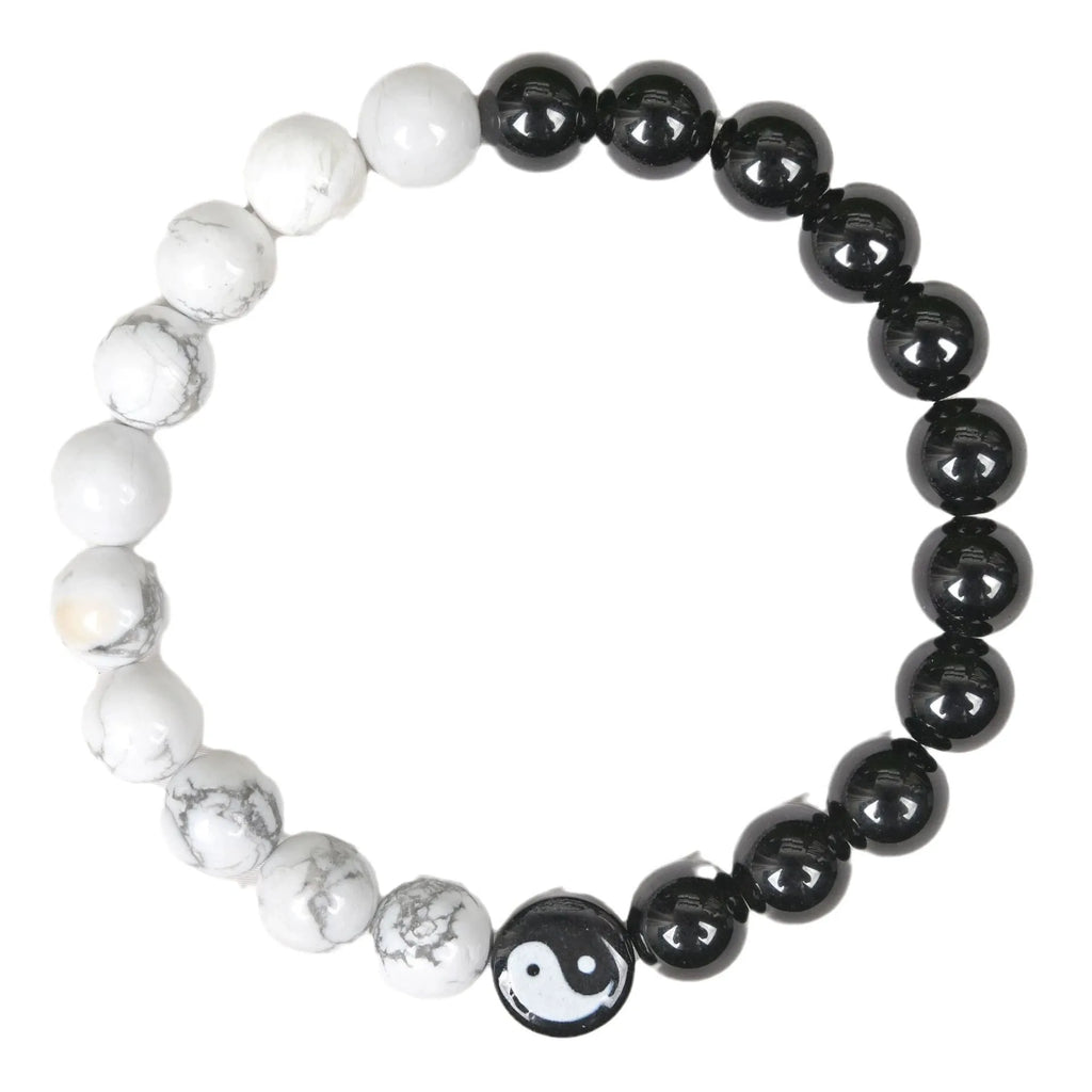 White turquoise and natural obsidian 8mm bead bracelet on a flat surface