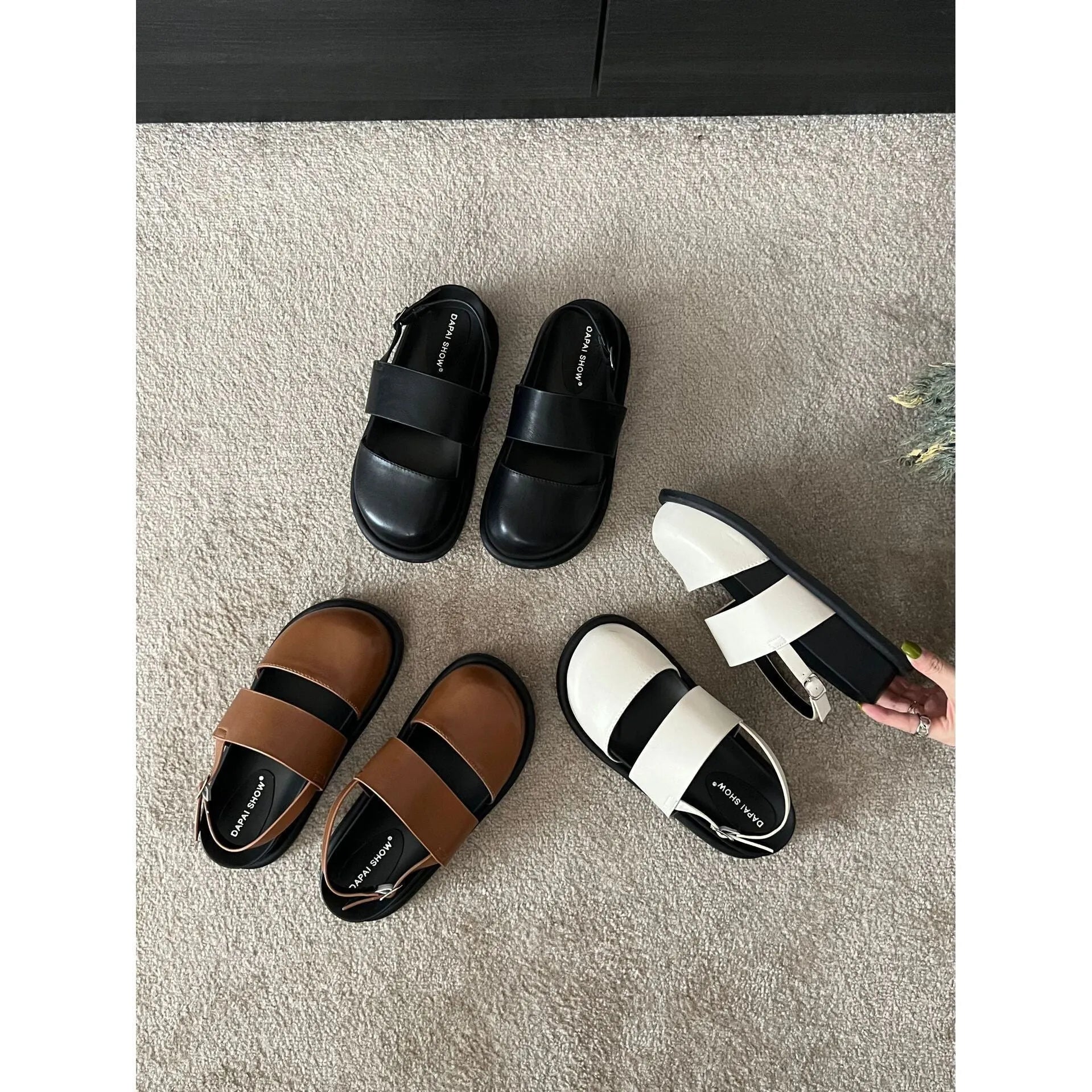 Korean style women's retro sandals with a black microfiber upper and adjustable ankle buckle on a PVC sole.